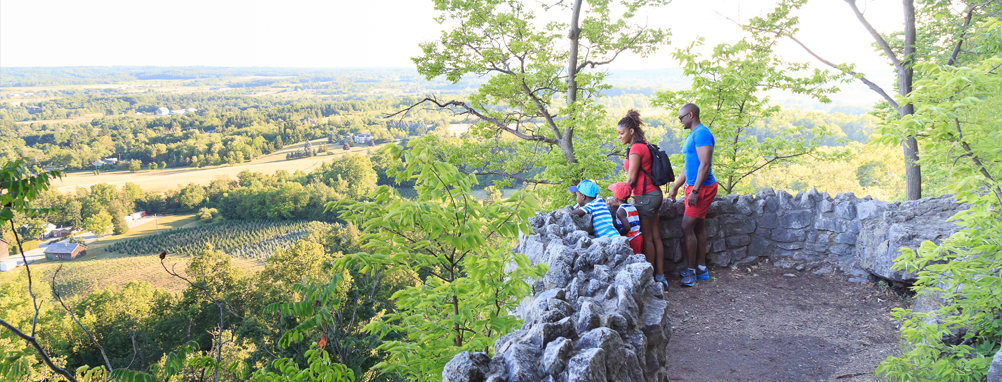 a family looking out over the Niagara Escarpment at Milton