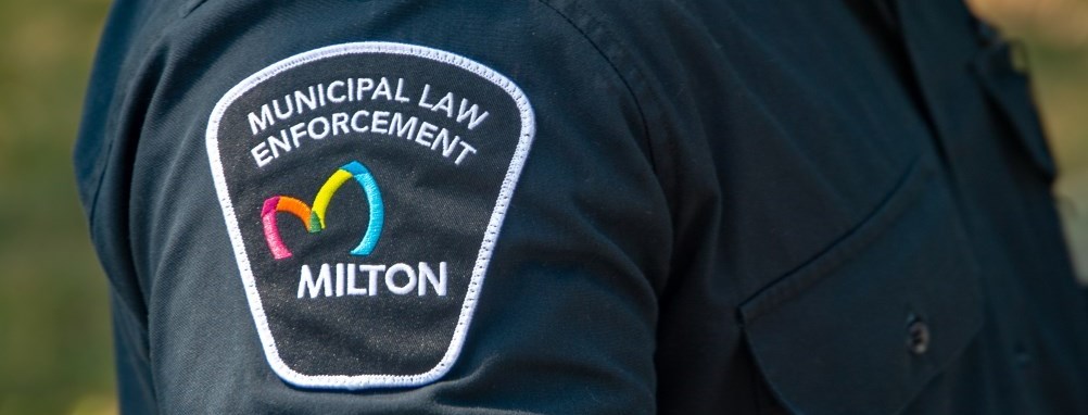 A Milton bylaw officers arm patch of his uniform.